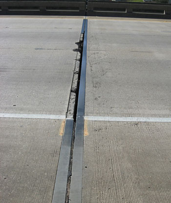 Figure 1. Photo. A close-up view of a bridge deck in Louisiana before bridge deck joint replacement was performed. Deterioration is visible on the bridge deck.