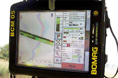 A close-up of the color-coded display screen of an intelligent compaction roller.
