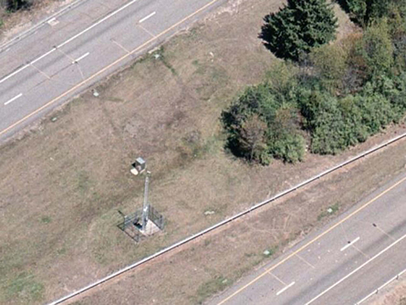 An aerial view of a WIM data collection site in a grassy median on I-84 in Connecticut.
