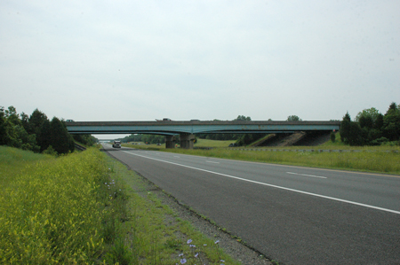 Figure 6. Photo. In the background is a bridge that carries Southbound U.S. Route 15 over Interstate 66 in Prince William County, VA.
