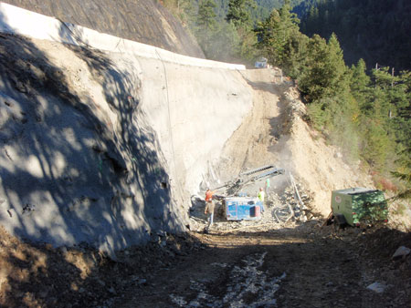 FHWA's Central Federal Lands Highway Division installs hollow bar soil nails in an earth retaining structure on South Fork Smith River Road in California.