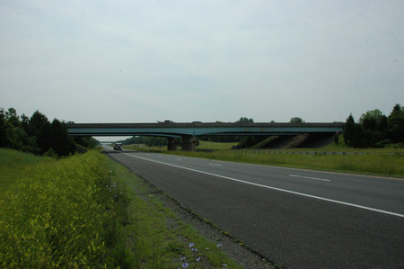 A front view of a continuous steel stringer bridge that carries Southbound U.S. Route 15 over Interstate 66 in Prince William County, VA. A truck is approaching the bridge's underpass on Interstate 66.