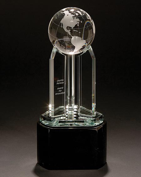 The image shows the Charles Pankow Award for Innovation, which is a glass globe on top of glass supports. The glass portion of the award sits atop a solid base.