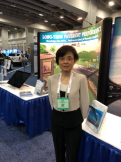 Dr. Ping Lu standing in front of FHWA's Long-Term Pavement Performance booth at the 2019 TRB Annual Meeting.