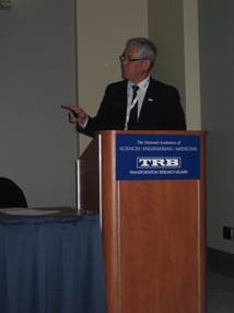 The photograph shows Randy Iwasaki member of Transportation Research Board member presiding over Long-Term Pavement Performance (LTPP) State Coordinators Meeting.