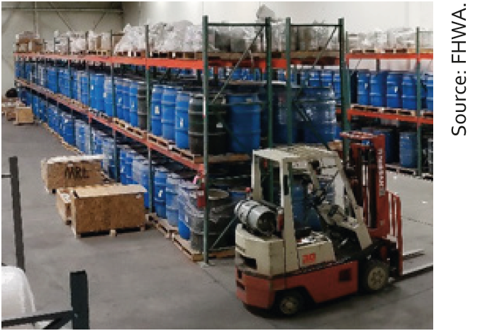 Figure 2. Photo. View of the new Materials Reference Library facility. This a photo shows the west partition of the Materials Reference Library warehouse. The staging area for outgoing and incoming shipments is shown in the foreground. Source: FHWA.