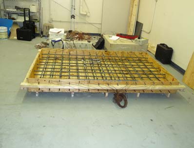 Figure 6. Photo. Bridge deck specimen with reinforcing bars.