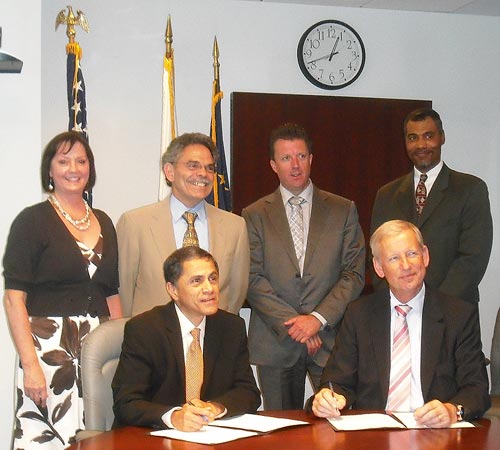 (Standing left to right) Federal Highway Administration (FHWA) representatives Debra Elston and Michael Trentacoste, Forum of European National Highway Research Laboratories (FEHRL) Steve Phillips, and FHWA’s Ian Saunders witness the signing of the Memorandum of Cooperation between FHWA and FEHRL to establish a business protocol aimed at optimizing collaboration. (Sitting left to right) FHWA’s Victor M. Mendez and FEHRL’s President Joris Al.