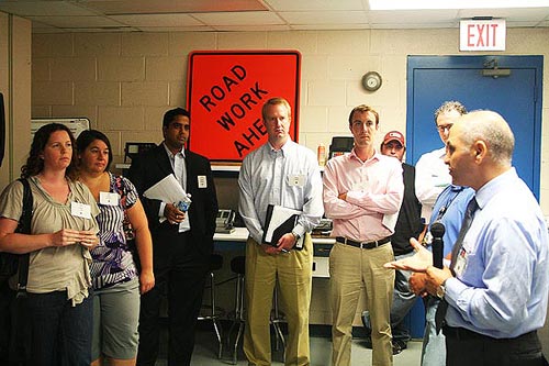 FHWA’s Hamid Ghasemi briefs the visitors on research being conducted in the Nondestructive Evaluation Laboratory to improve the state of the practice for highway bridge inspection.