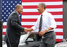 Transportation Secretary Anthony J. Foxx (left) and Michael Trentacoste, the director of the Turner-Fairbank Highway Research Center, shake the hand of the President as FHWA employees look on.