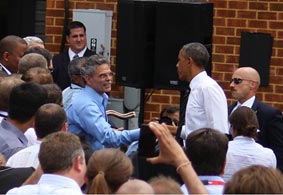 Transportation Secretary Anthony J. Foxx (left) and Michael Trentacoste, the director of the Turner-Fairbank Highway Research Center, shake the hand of the President as FHWA employees look on.