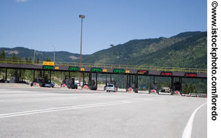 Photo. A view of toll booths in the road ahead.