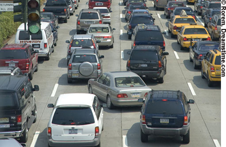 Photo. A view of a congested highway and a driver making a sudden lane change in traffic.