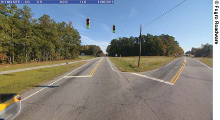Figure 5. Photo. A frame from a sequence of photographs shows an intersection ahead with overhead stoplights.