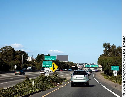 An in-car view of traffic merging onto a freeway.