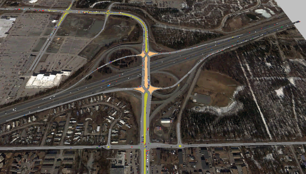 A screen capture of a simulation video shows a birdâ€™s eye view of a highway exit. Yellow and orange lines identify different sections of the highway.