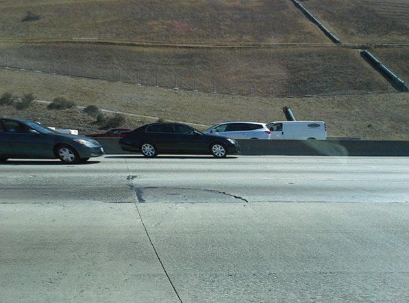 Photo of pavement slabs on the Pomona Highway (also known as California SR 60). This section of the Pomona Highway was constructed the year before the photo was taken, but there is already evidence of joint spalling and corner cracking.