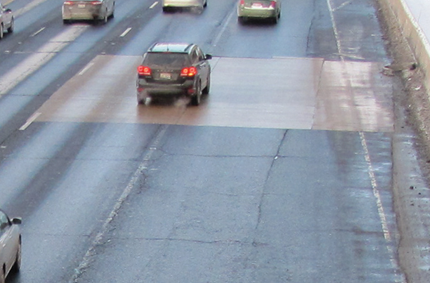 Photo of vehicles driving over a section of Interstate 90/94 in Chicago that was repaired with calcium aluminate concrete; the repairs are in good shape after 5 years of use. 