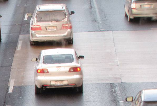 Photo of vehicles driving over a section of Interstate 90/94 in Chicago that was repaired with calcium aluminate concrete; the repairs are in good shape after 5 years of use.