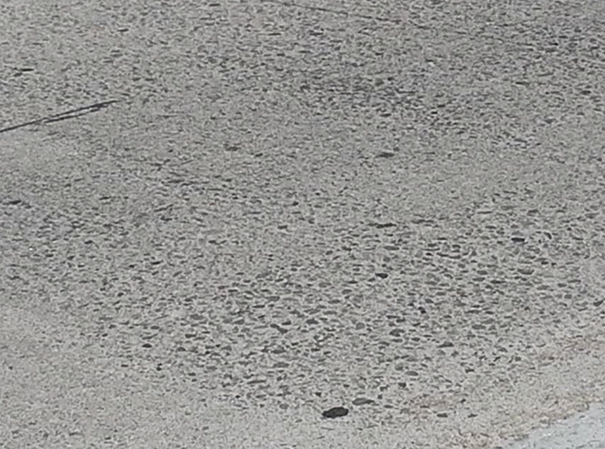 Close-up photo of the Route 60E/71N interchange near Los Angeles. Some surface wear is apparent, but otherwise the road surface is in good condition.  
