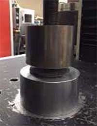 Photo on the right shows a close view of the threaded shaft, the ram, and a cylindrical base plate that supports material being tested.