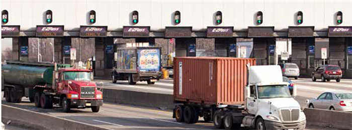 This photo shows vehicles moving through toll booths equipped with ETC technology on a multilane bridge in New Jersey.