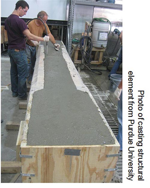 Photo shows casting of structural element in a laboratory from Purdue University.  Two men with different tools in their hands are shown testing and preparing a structure that appears to be encased in a wooden frame that is on wood studs placed on the floor in a laboratory. Other equipment and supplies are visible in the background.