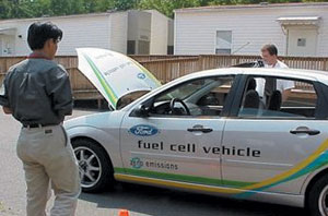 Visitors examine alternative fuel vehicle.