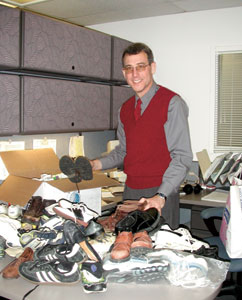Carl Andersen sorts through shoe donations for children in Afghanistan.
