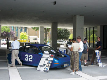 Working with AJ Nedzesky of the Office of Safety R&D, Western Washington University students exhibit the Viking 32 natural gas and electric hybrid at USDOT headquarters, Nassif Building.