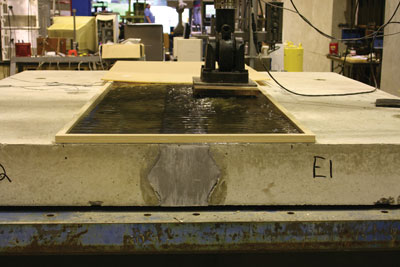 Ultra-high performance concrete testing equipment operating on large forms in a laboratory at FHWA's Turner-Fairbank Highway Research Center in McLean, VA.