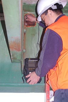 A stock photo shows a worker operating the Eddy Current system, a nondestructive evaluation system for bridges.