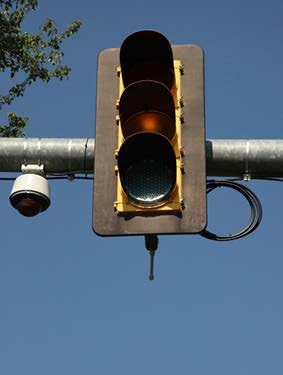 A stock photo shows a traffic signal light attached to a metal bar