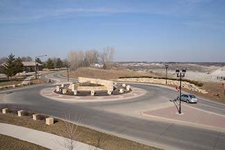 A stock photo shows an overhead view of an empty roundabout.