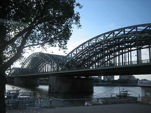 A stock photo shows an arch bridge extending over a wide expanse of water.