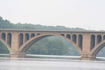 Stock photo shows the side view of an arch bridge.