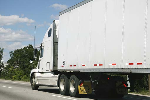 Stock photo shows a semi-trailer on a highway.