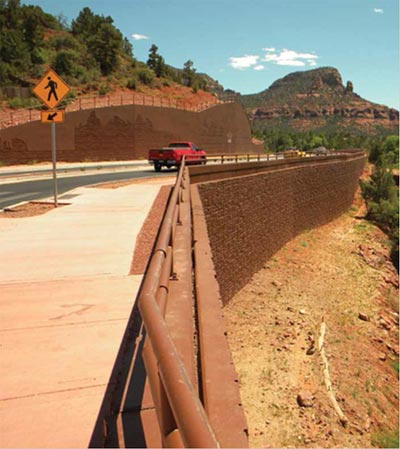 This figure shows a newly reconstructed and environmentally sensitive business-tourist corridor with new vehicle lanes, pedestrian pathways, and structural retaining walls, developed as part of an FHWA project. (Image source: FHWA)