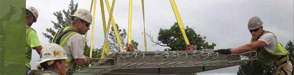 This figure shows pre-cast concrete deck panels aligned on top of steel bridge girders as part of an FHWA Highways for LIFE project implemented by Minnesota DOT to replace a deteriorated bridge using ABC techniques. (Image source: FHWA)