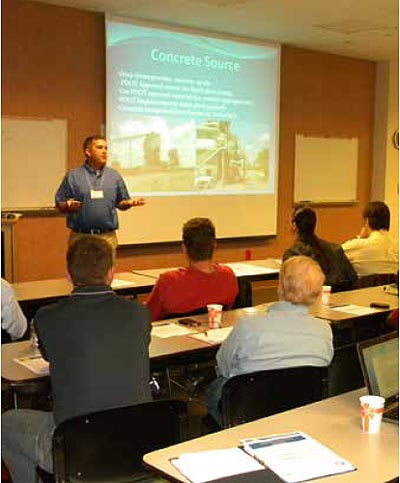 This figure shows Jeremy Walcott, P.E., giving an overview of a FHWA Highways for LIFE construction project at a showcase held at the Florida DOT District 5 office. (Image source: FHWA)