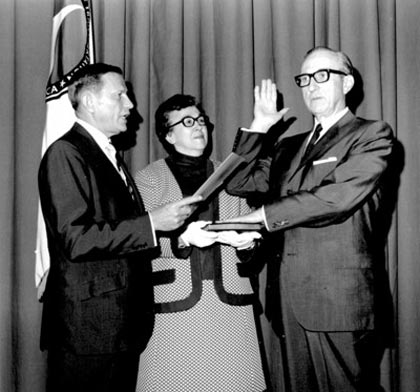 On May 8, 1969, Secretary of Transportation John A. Volpe administered the oath of office to Director of Public Roads Ralph R. Bartelsmeyer, whose wife Marjorie held the Bible.