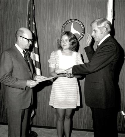 Secretary of Transportation Claude S. Brinegar administered the oath of office to Federal Highway Administrator Norbert T. Tiemann on June 1, 1973. Tiemann’s daughter Mary held the Bible.