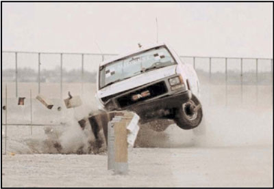 Truck crashing into a guardrail during a crash test