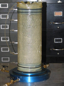 This photo shows a soil specimen used in triaxial tests. The specimen is cylindrical and smooth. 