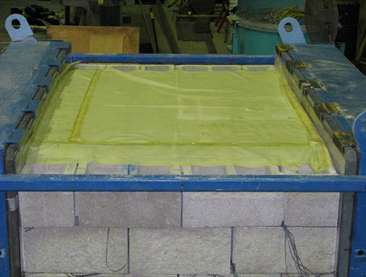 This photo shows the top of the composite mass, where a thin sheet of yellow membrane has been glued to the surface.