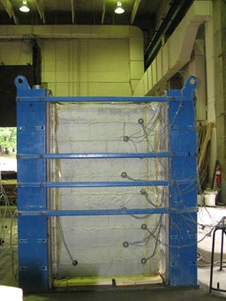 This photo shows one side of the test bin, with the completed composite mass and strain gauges visible.