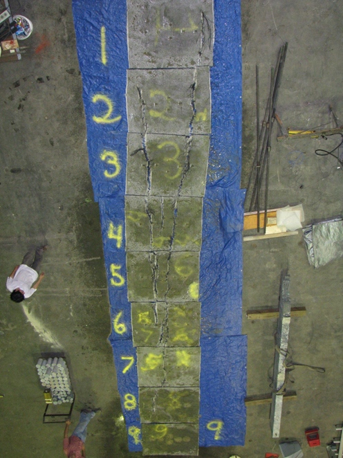 This photo shows all of the geosynthetic reinforcement layers from the test 2 composite mass. Clear rupture lines can be seen, which highlight the location of maximum strain.