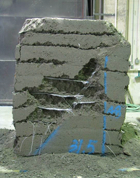 This figure shows the front side of the test 5 composite mass after it was removed from the test bin. The mass shows a clear, diagonal failure plane on the side of the mass.