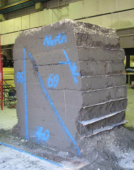 This figure shows the back side of the test 5 composite mass after it was removed from the test bin. The mass shows a clear, diagonal failure plane on the side of the mass.