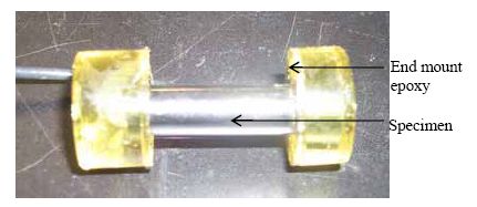 The photo shows an A S T hyphen 2 B specimen with electrical lead and epoxy end coating.